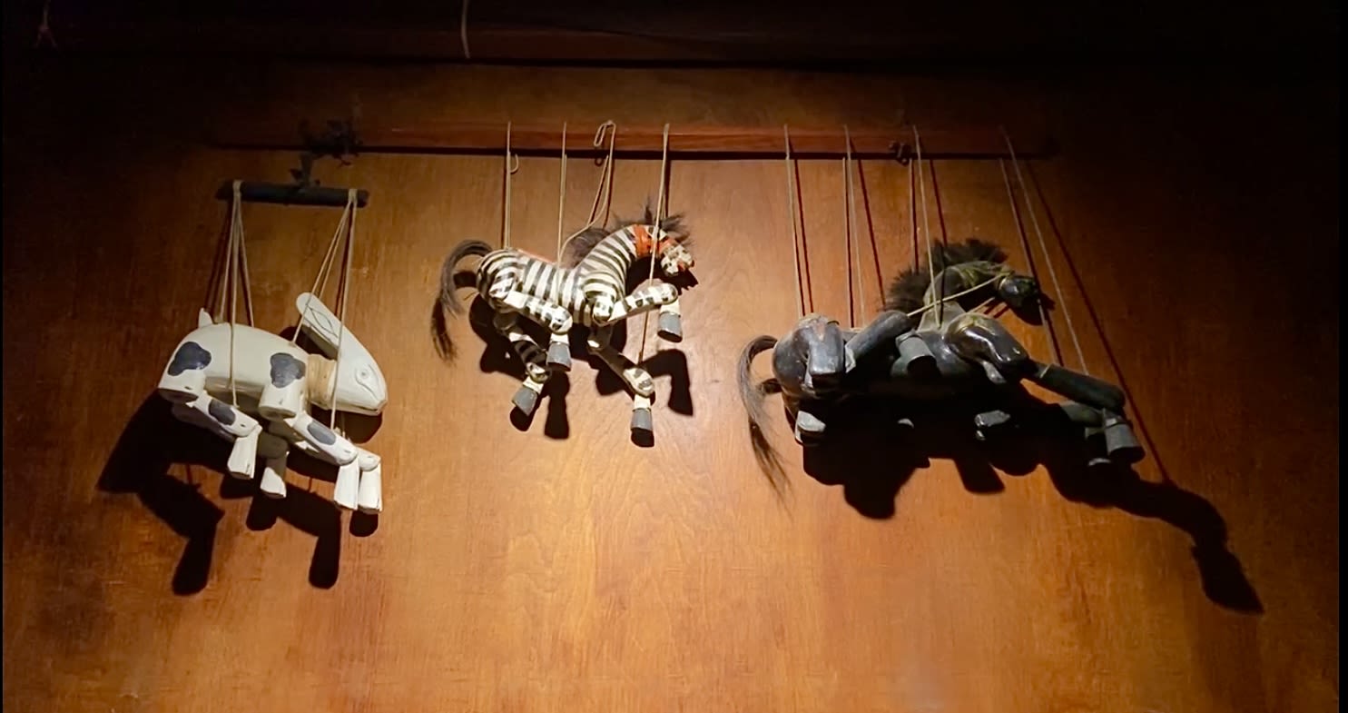 selective focus photography of deity marionettes