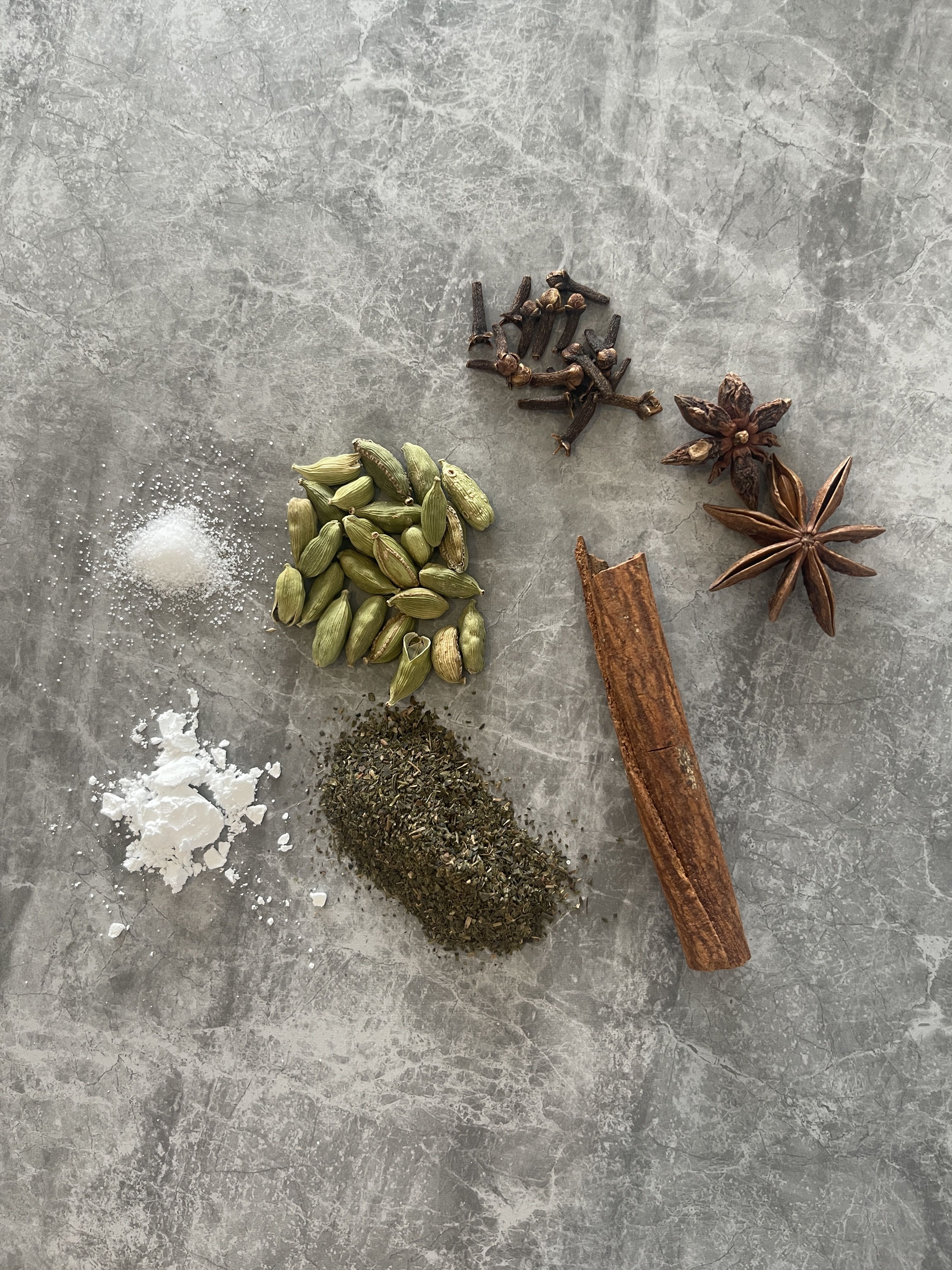 Kashmiri chai, also known as pink tea or noon chai, uses a blend of spices including green cardamom, cinnamon, star anise, and cloves, along with green tea leaves, milk and sometimes a pinch of salt or sugar. The addition of baking soda turns the green tea pink