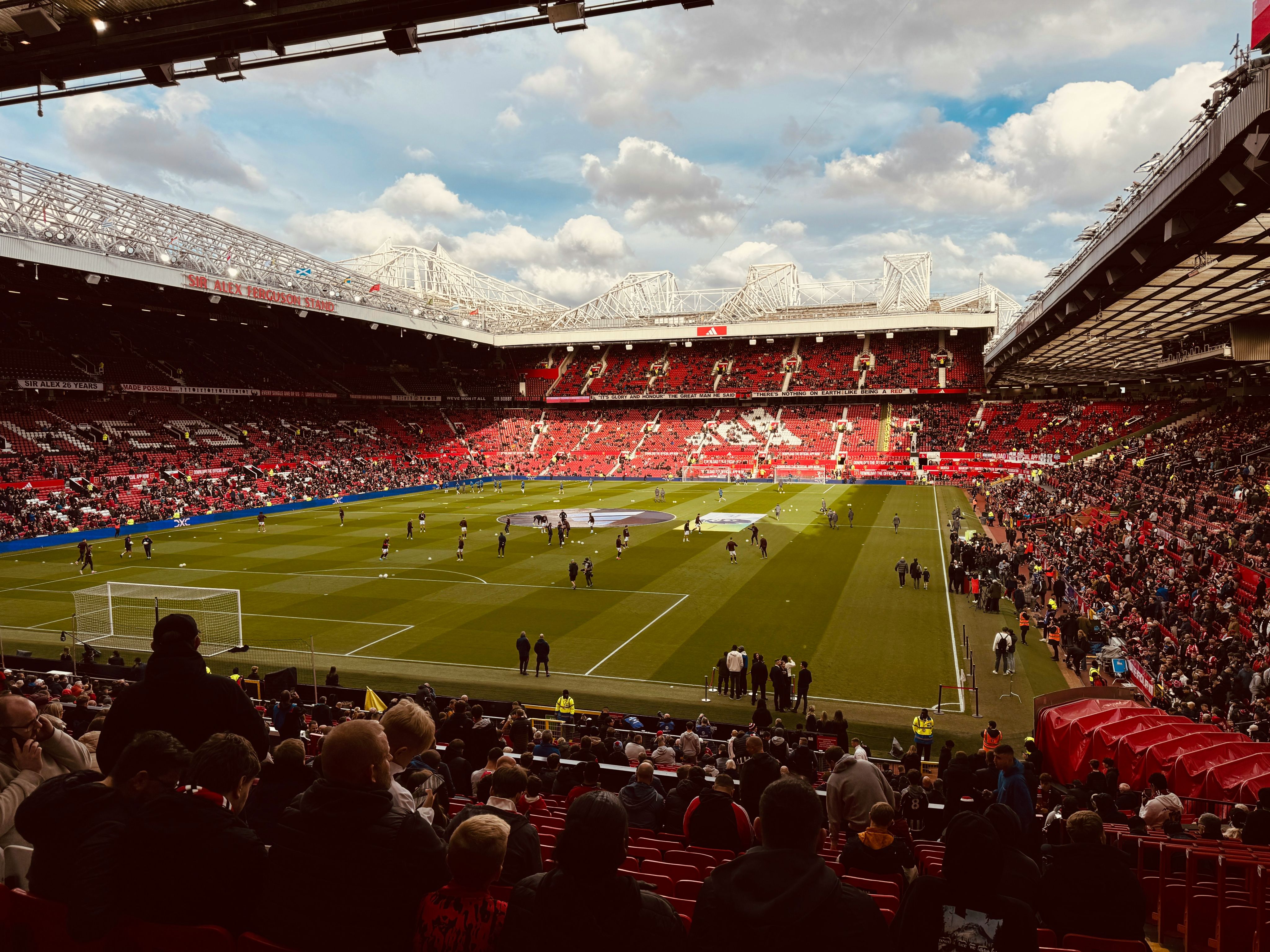 A stadium filled with lots of people watching a soccer game