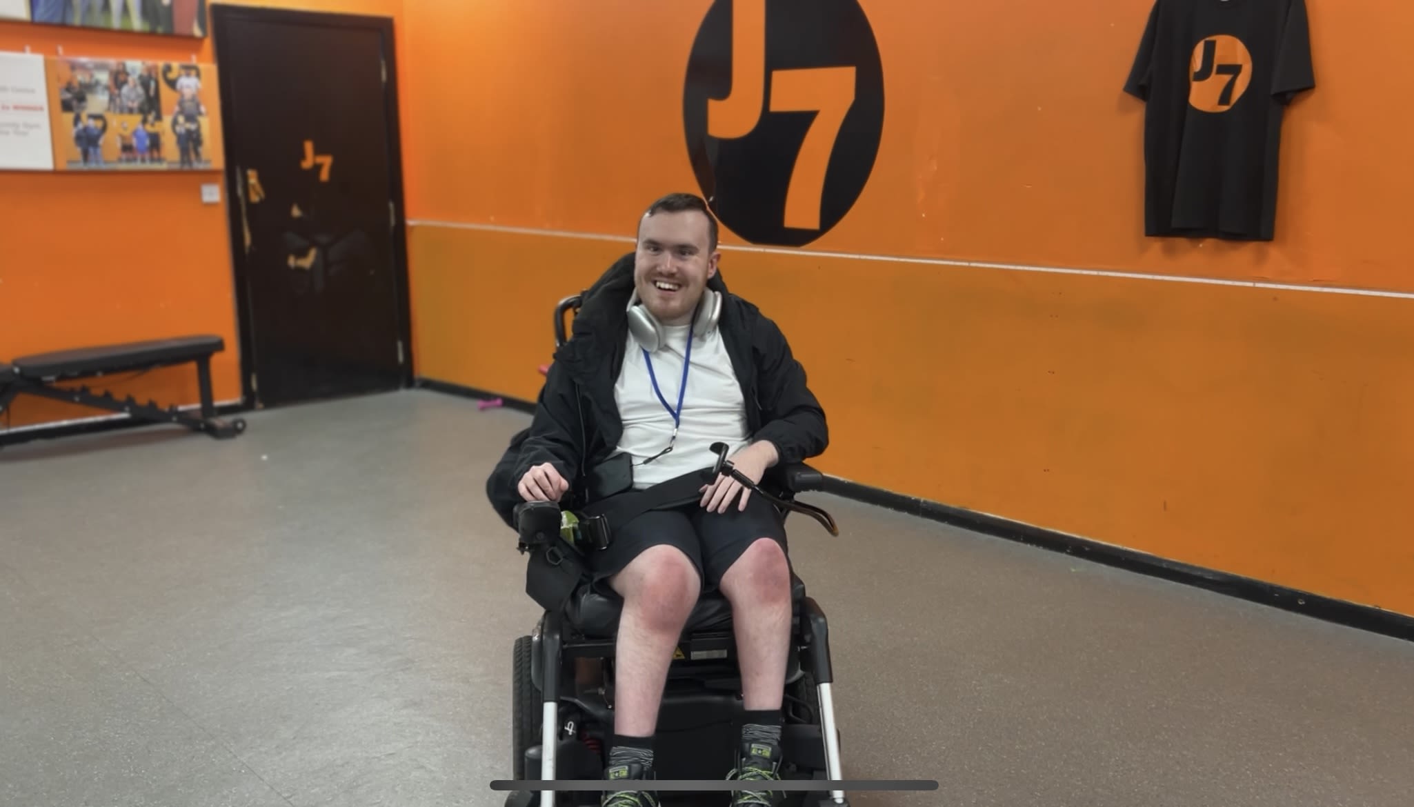 photo of Josh sat in his chair smiling