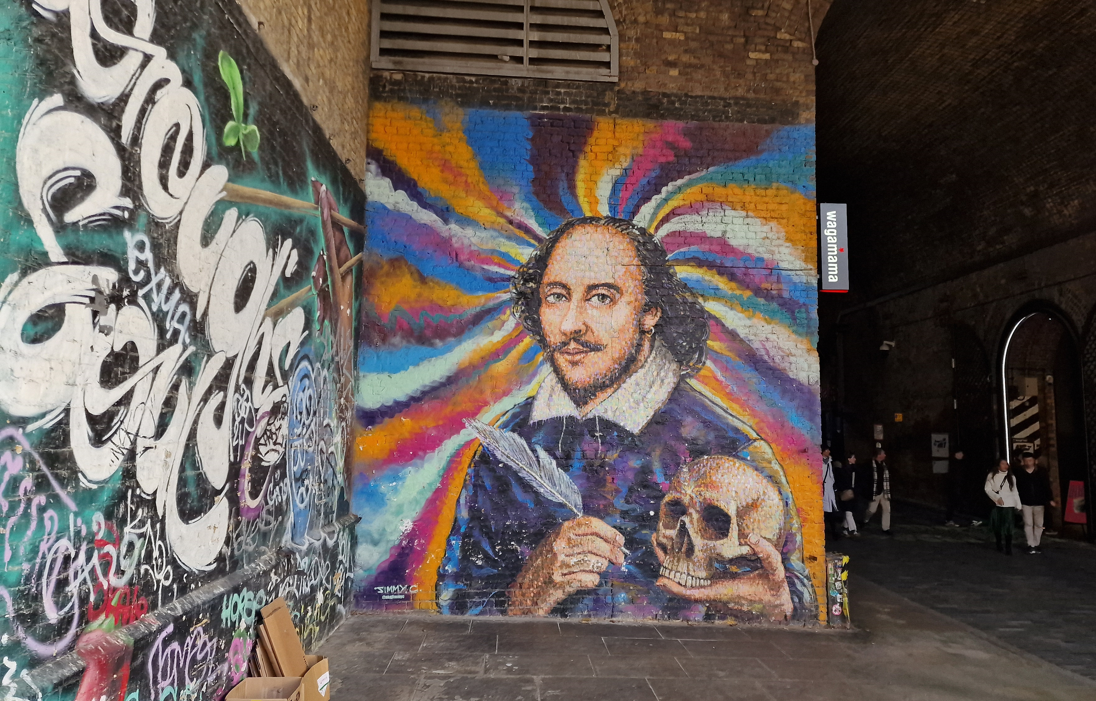 A mural by street artist Jimmy C, colourfully depicting Shakespeare with a quill in one hand and a skull in the other. Photograph taken by Piers Mucklejohn.